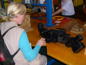Kate starting to build the tallest possible structure with polycube blocks at Babylon Centrum